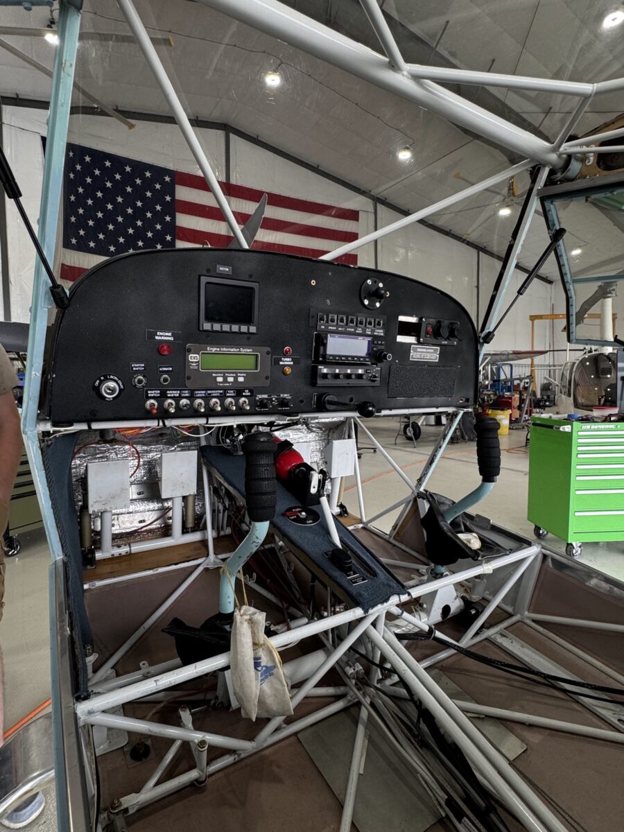 Technician working behind an avionics panel